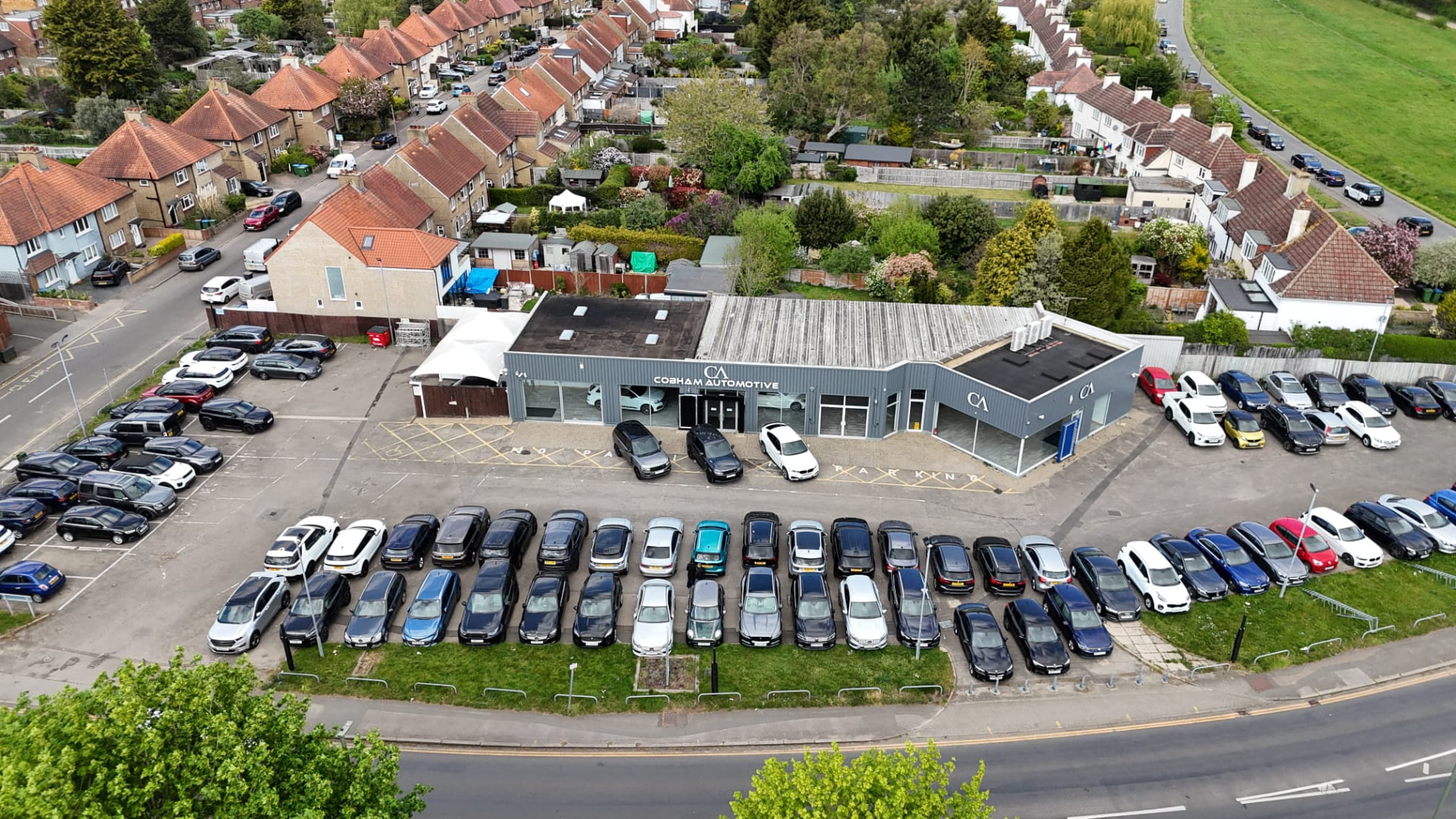 Aerial view of the Cobham Automotive forecourt full of used cars